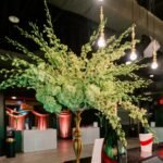 Elegant white floral arrangement on display at the Carnivale du Vin gala at The Fillmore in New Orleans, adding a touch of sophistication to the event décor.